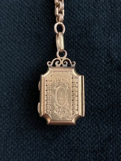 Yellow gold vest chain with two charms and...