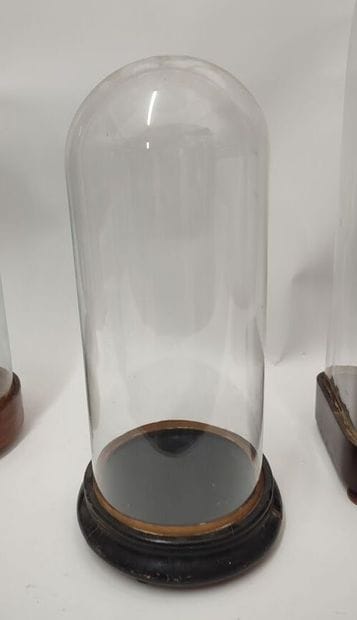 Set of three glass globes, wooden base 
one...
