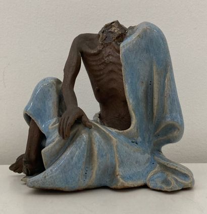 Stoneware figure, blue enamel tunic
Height...