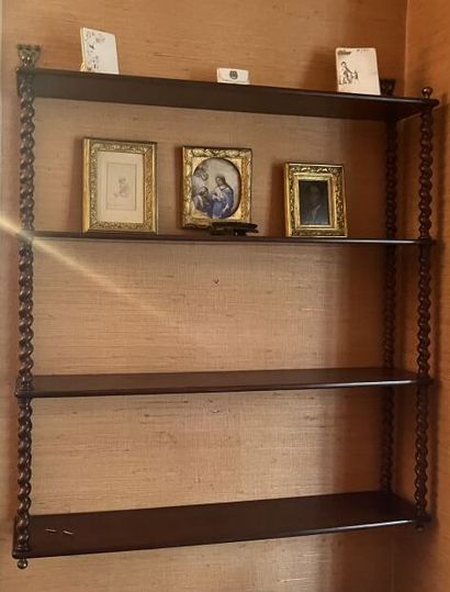 Wall-mounted bookshelves with turned wood...