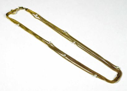 Collier souple quatre rangs en or jaune 18K,...