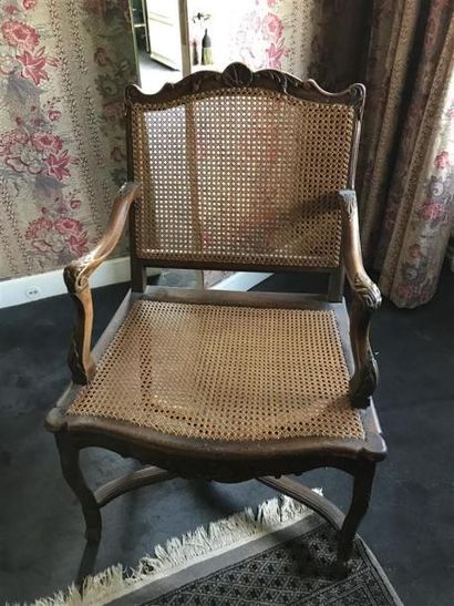 Fauteuil canné, les pieds cambrés réunis...