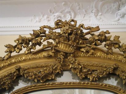 Grand miroir en bois et stuc doré à décor...