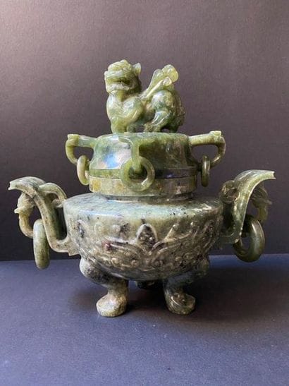 Covered pot topped with a green hard stone...