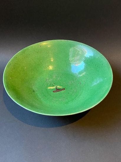 Flared bowl of green porcelain with plant...