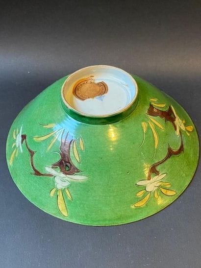 Flared bowl of green porcelain with plant...