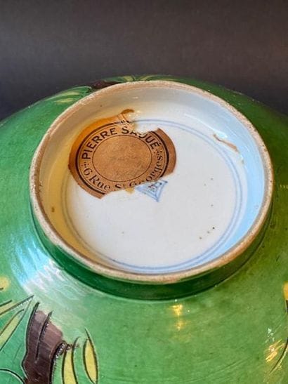 Flared bowl of green porcelain with plant...