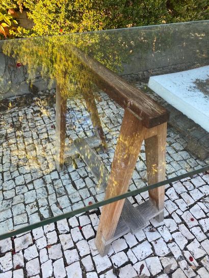 Large glass tray resting on two wooden trestles...