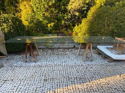 Large glass tray resting on two wooden trestles...