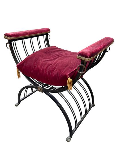 Two wrought-iron curved stools with crimson...