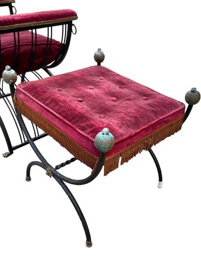 Two wrought-iron curved stools with crimson...