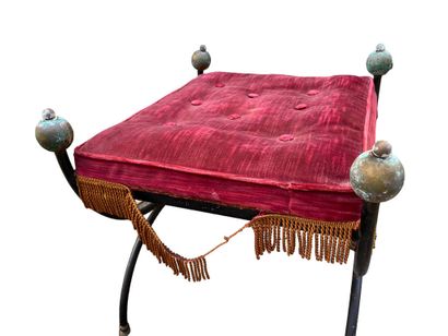 Two wrought-iron curved stools with crimson...