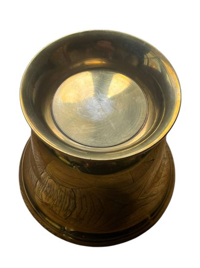 Gilded metal bowl on pedestal featuring a...