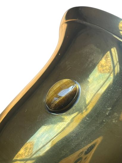 Gilded metal bowl on pedestal featuring a...