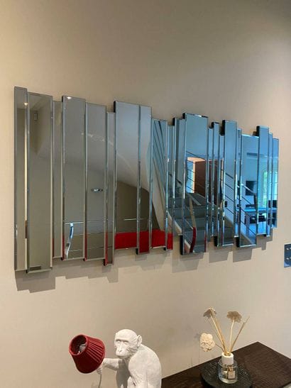 Large contemporary mirror composed of a succession...