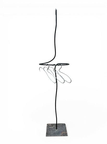 Free-form, patinated wrought-iron valet.
Three...