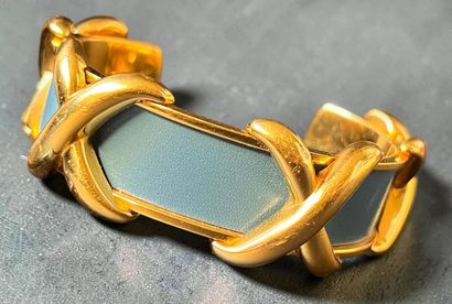 HERMÈS
Rigid gold-plated metal and blue leather...