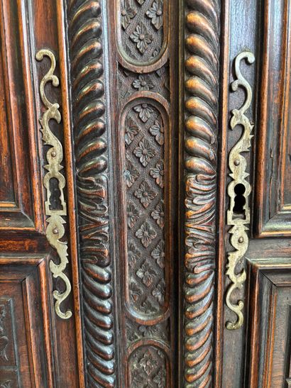 Carved walnut armoire opening on two doors,...