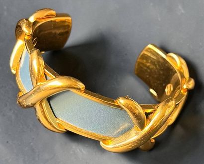 HERMÈS
Rigid gold-plated metal and blue leather...