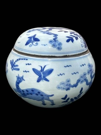 Porcelain covered pot decorated with plants...