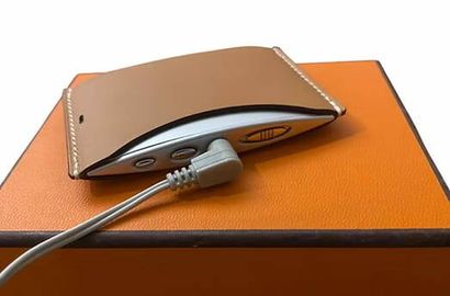 HERMÈS 
Portable radio in Swift Gold leather...