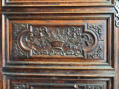 Carved walnut armoire opening on two doors,...