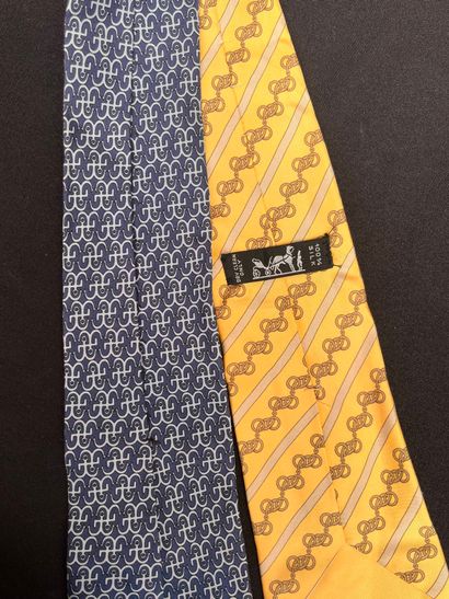 HERMÈS
Set of two printed silk ties, one...