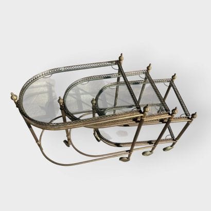 JANSEN
Three nesting side tables in brass...