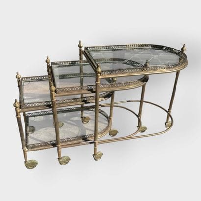 JANSEN
Three nesting side tables in brass...