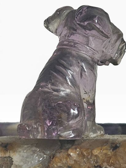 A ring holder carved from amethyst, topped...