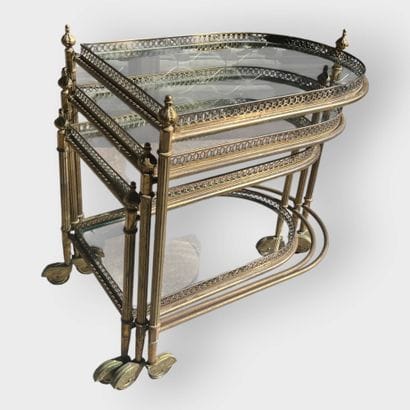 JANSEN
Three nesting side tables in brass...