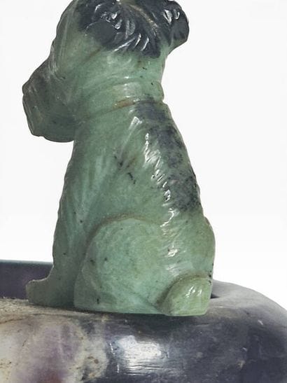A ring holder carved from amethyst, topped...