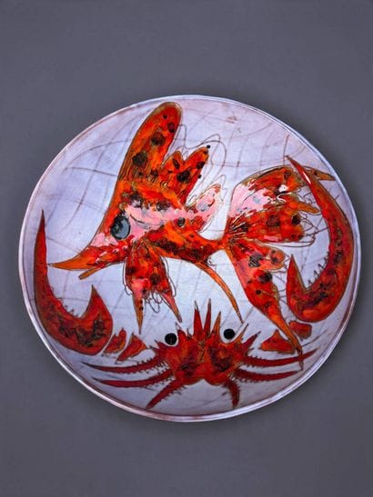 Large circular dish made of glazed red earthenware,...