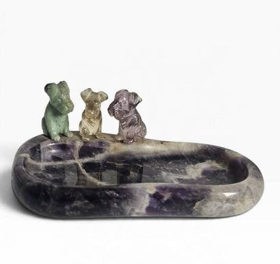 A ring holder carved from amethyst, topped...