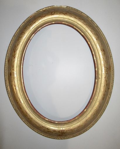Cadre oval en bois et pâte doré à profil...