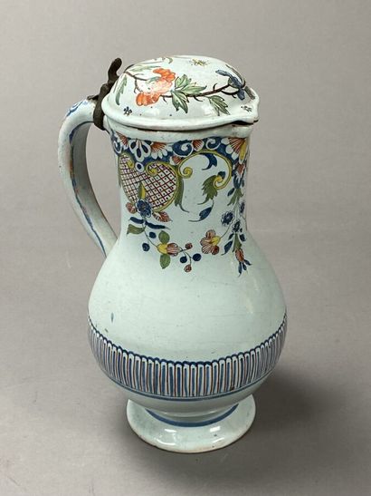 Enameled earthenware jug decorated with flowers...