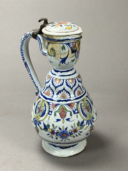 Enamelled earthenware jug with floral decoration...
