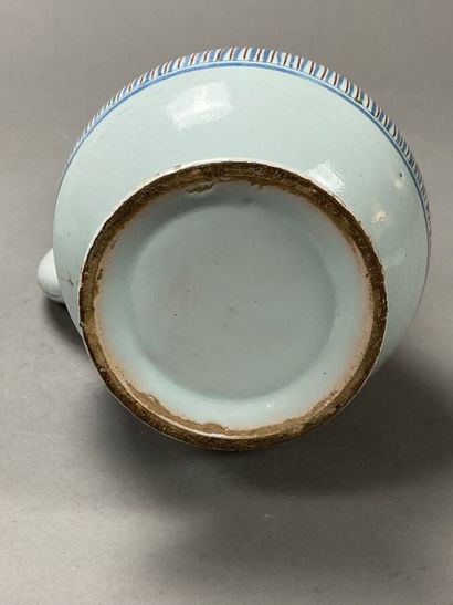 Enameled earthenware jug decorated with flowers...