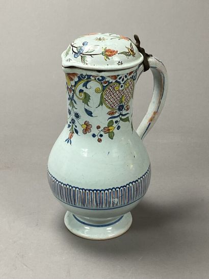 Enameled earthenware jug decorated with flowers...