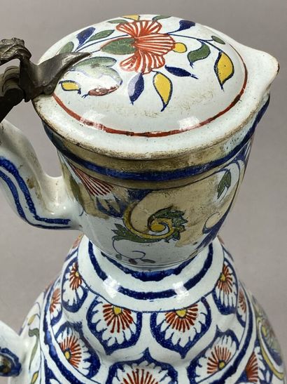 Enameled earthenware jug decorated with flowers...