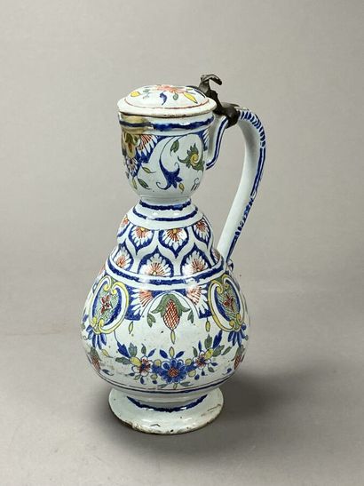 Enamelled earthenware jug with floral decoration...