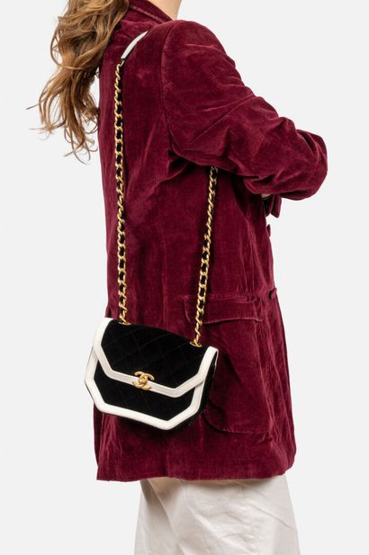 CHANEL
Black velvet flap bag trimmed with...