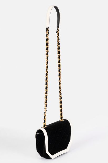 CHANEL
Black velvet flap bag trimmed with...
