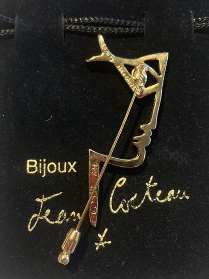 After Jean COCTEAU,
Profile
Gilt metal brooch...