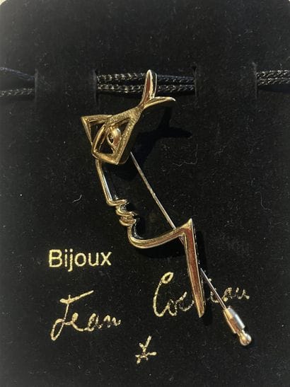 After Jean COCTEAU,
Profile
Gilt metal brooch...