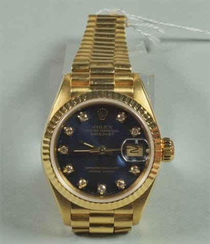 ROLEX
Montre de dame en or jaune 18K (750/oo),...