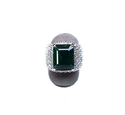 White gold ring centered with a large emerald...