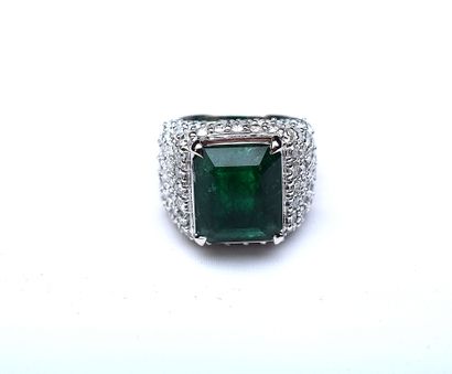 White gold ring centered with a large emerald...