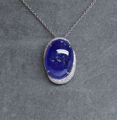 White gold pendant holding a large oval cabochon...