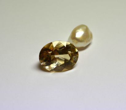 A large oval smoky quartz on paper weighing...